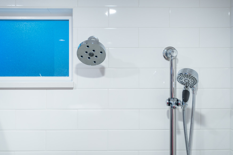 Bathroom - mid-sized traditional master white tile and ceramic tile porcelain tile bathroom idea in Portland with recessed-panel cabinets, white cabinets, a two-piece toilet, blue walls, an undermount sink and quartz countertops