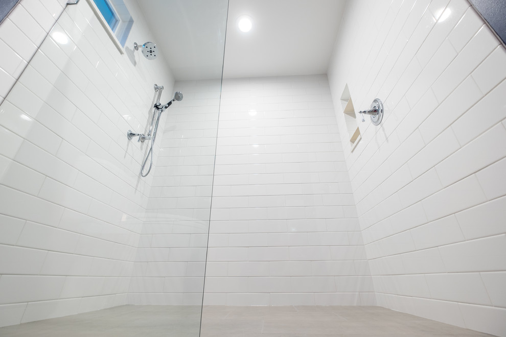 Inspiration for a mid-sized timeless master white tile and ceramic tile porcelain tile bathroom remodel in Portland with recessed-panel cabinets, white cabinets, a two-piece toilet, blue walls, an undermount sink and quartz countertops