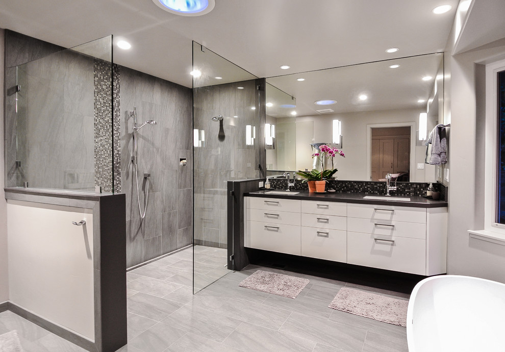 Design ideas for a medium sized traditional ensuite bathroom in San Francisco with flat-panel cabinets, white cabinets, a freestanding bath, a corner shower, grey tiles, ceramic tiles, grey walls, ceramic flooring and granite worktops.