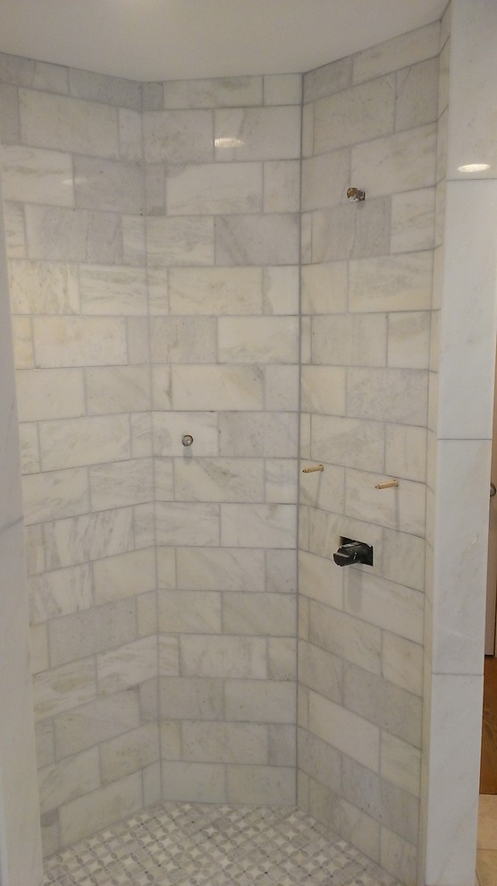 Trendy gray tile and subway tile corner shower photo in Austin