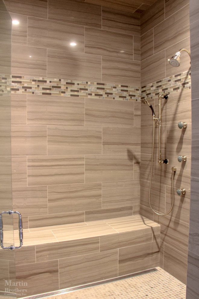 This is an example of a large traditional ensuite bathroom in Other with raised-panel cabinets, dark wood cabinets, a freestanding bath, a built-in shower, a one-piece toilet, grey walls, marble flooring, a submerged sink, granite worktops, beige floors, a hinged door, a shower bench, double sinks and a built in vanity unit.
