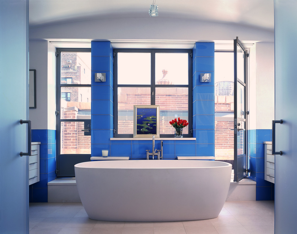 Example of a trendy glass tile and blue tile bathroom design in New York