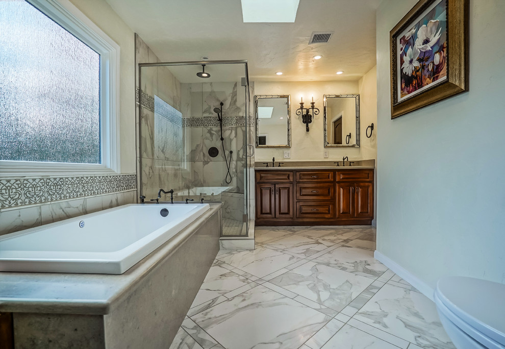 Bathroom - large traditional master gray tile, white tile and porcelain tile porcelain tile and white floor bathroom idea in Los Angeles with raised-panel cabinets, dark wood cabinets, a two-piece toilet, gray walls, an undermount sink, concrete countertops and a hinged shower door