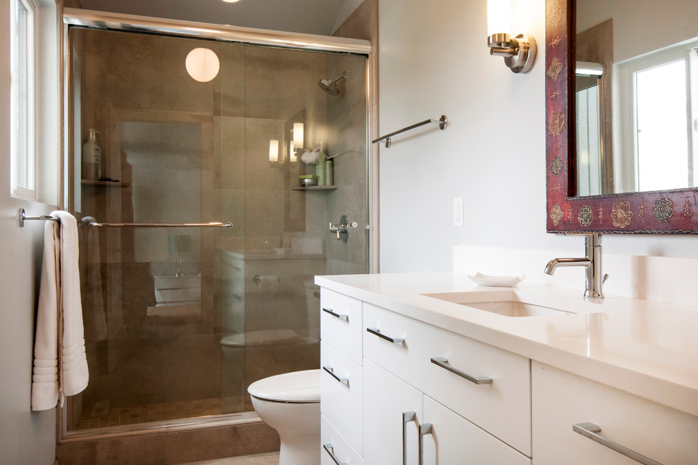 Photo of a medium sized contemporary ensuite bathroom in Boise with a submerged sink, flat-panel cabinets, white cabinets, granite worktops, a two-piece toilet, brown tiles, ceramic tiles, grey walls and ceramic flooring.