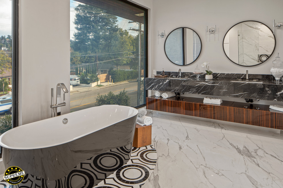 Bathroom - large modern master marble floor, white floor and double-sink bathroom idea in Los Angeles with flat-panel cabinets, dark wood cabinets, a one-piece toilet, white walls, an undermount sink, a hinged shower door, black countertops and a floating vanity