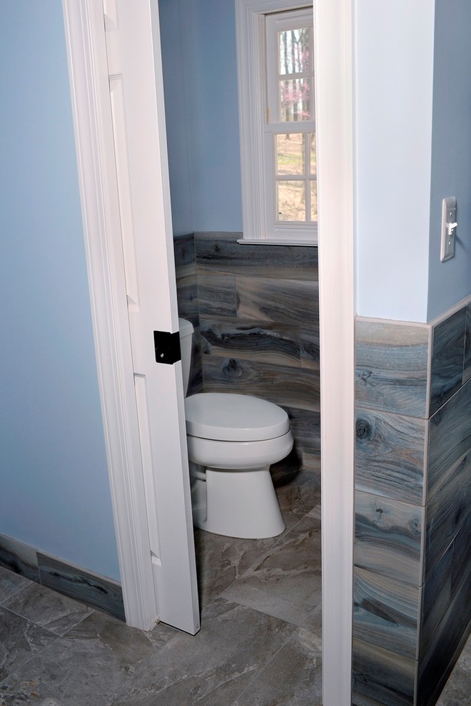 Example of a large trendy master gray tile and porcelain tile porcelain tile and gray floor bathroom design in DC Metro with dark wood cabinets, a two-piece toilet, blue walls, an undermount sink, granite countertops and beige countertops