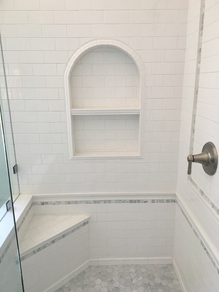 Medium sized beach style ensuite bathroom in Los Angeles with shaker cabinets, white cabinets, a corner shower, white tiles, metro tiles, blue walls, porcelain flooring, a submerged sink and marble worktops.