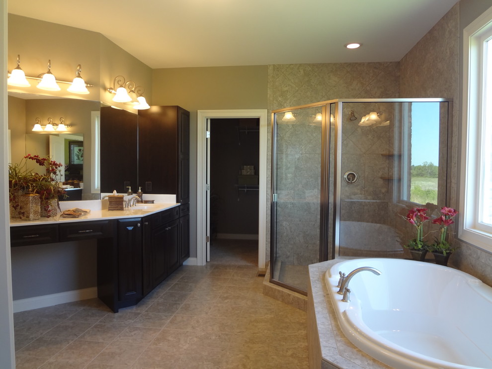 На фото: главная ванная комната в классическом стиле с фасадами с выступающей филенкой, темными деревянными фасадами, накладной ванной, угловым душем, бежевыми стенами и врезной раковиной с