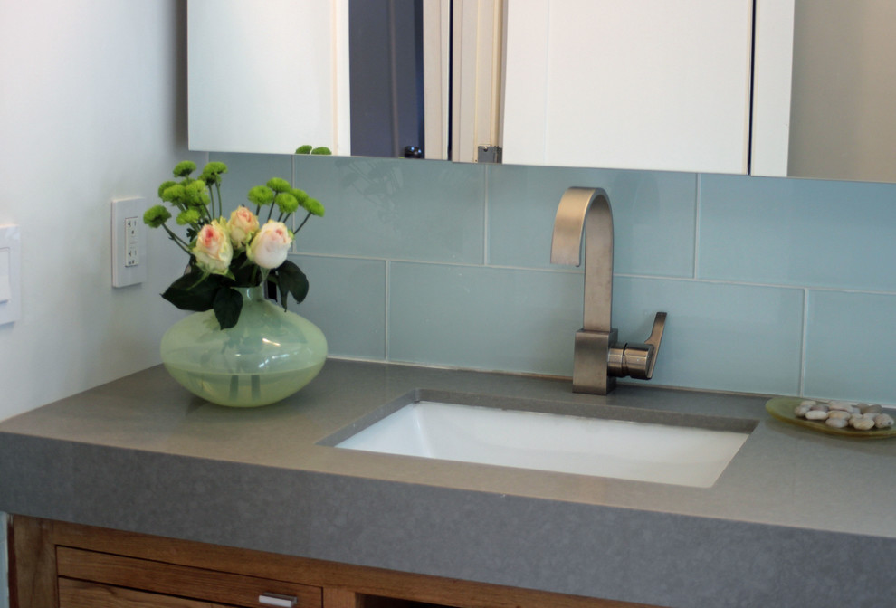 Example of a mid-sized trendy master blue tile and glass tile ceramic tile tub/shower combo design in San Francisco with an undermount sink, recessed-panel cabinets, medium tone wood cabinets, granite countertops, a two-piece toilet and white walls