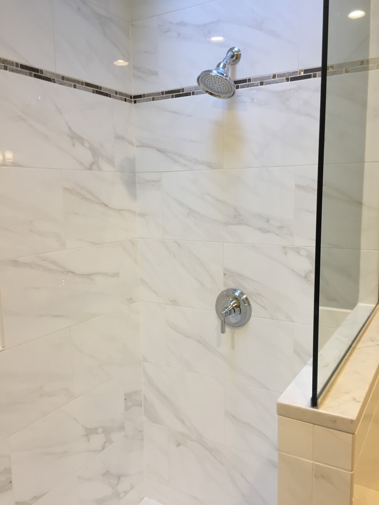 This is an example of a medium sized traditional ensuite bathroom in St Louis with recessed-panel cabinets, medium wood cabinets, a built-in bath, a built-in shower, a one-piece toilet, white tiles, ceramic tiles, green walls, ceramic flooring, a built-in sink, engineered stone worktops, beige floors and a hinged door.