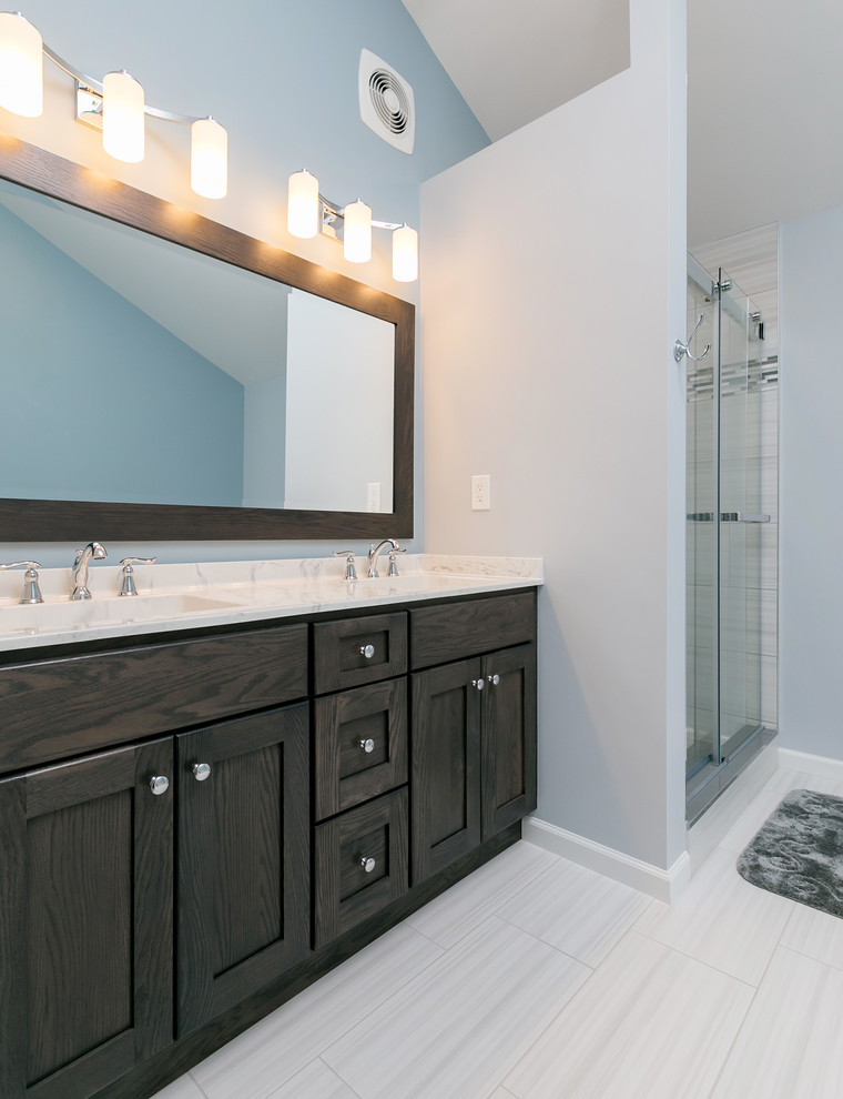 Photo of a contemporary ensuite bathroom in Philadelphia with dark wood cabinets, a freestanding bath, an alcove shower, white tiles, ceramic tiles, blue walls, porcelain flooring, an integrated sink, white floors and a sliding door.