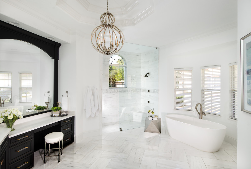 Large traditional ensuite bathroom in Orlando with recessed-panel cabinets, black cabinets, a freestanding bath, a walk-in shower, white tiles, marble tiles, white walls, marble flooring, engineered stone worktops, white floors, an open shower, white worktops, a built in vanity unit and a drop ceiling.
