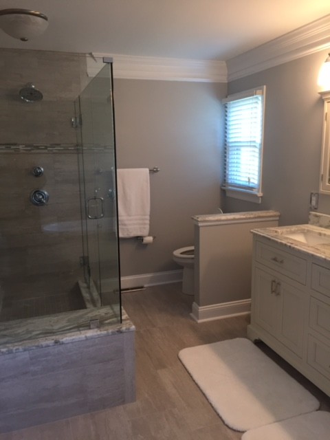 Photo of a medium sized classic ensuite bathroom in Richmond with recessed-panel cabinets, white cabinets, a claw-foot bath, a corner shower, a one-piece toilet, beige tiles, ceramic tiles, beige walls, ceramic flooring, a submerged sink and granite worktops.