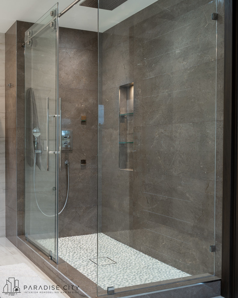 This is an example of a large contemporary ensuite bathroom in Miami with flat-panel cabinets, grey cabinets, a freestanding bath, a corner shower, a bidet, white tiles, porcelain tiles, white walls, porcelain flooring, an integrated sink, glass worktops, white floors, a sliding door, black worktops, a wall niche, double sinks and a floating vanity unit.
