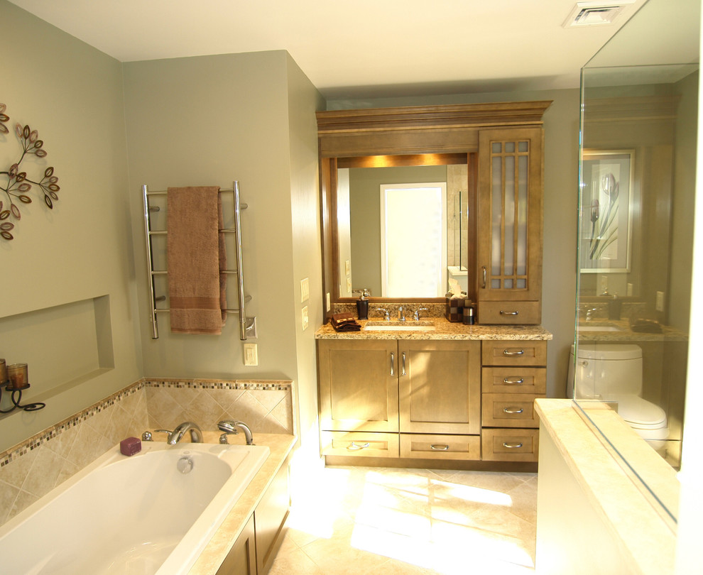 Photo of a medium sized traditional ensuite bathroom in Newark with flat-panel cabinets, light wood cabinets, a built-in bath, a corner shower, a one-piece toilet, green walls, ceramic flooring, a trough sink, a hinged door and multi-coloured worktops.