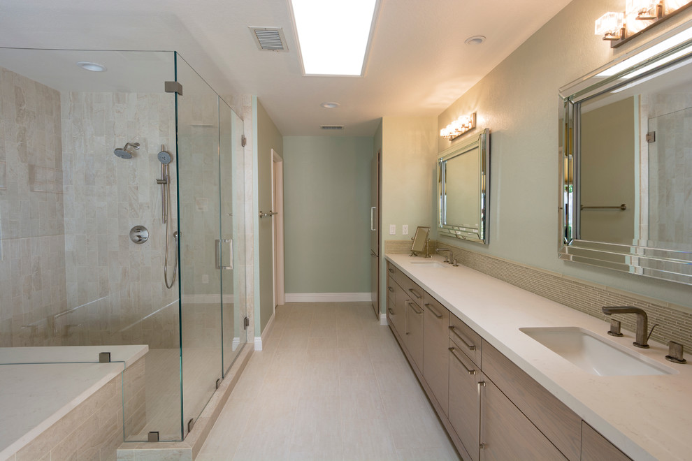 Photo of a large modern ensuite bathroom in Other with flat-panel cabinets, grey cabinets, a built-in bath, a shower/bath combination, a one-piece toilet, beige tiles, stone tiles, grey walls, limestone flooring, a submerged sink and engineered stone worktops.
