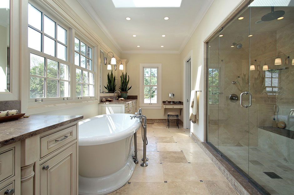 Inspiration for a large traditional ensuite bathroom in New York with raised-panel cabinets, a freestanding bath, an alcove shower, beige tiles, porcelain tiles, beige walls, a submerged sink, granite worktops and beige floors.