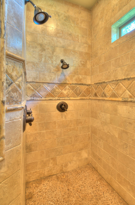 Large mountain style master brown tile and stone tile pebble tile floor double shower photo in Austin