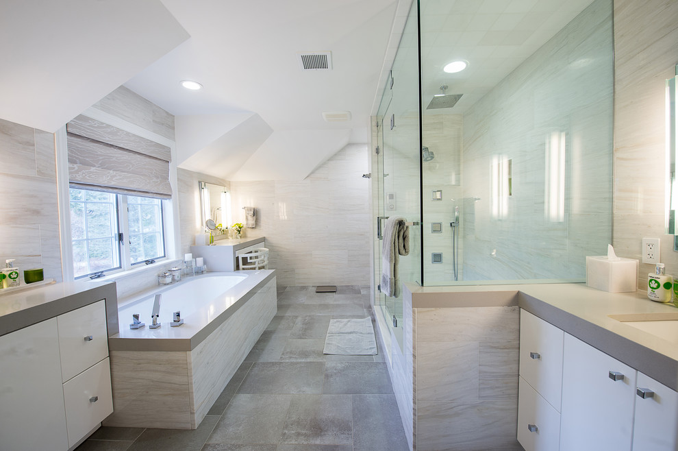 Example of a large transitional master gray tile and stone slab porcelain tile double shower design in New York with flat-panel cabinets, white cabinets, an undermount tub, a two-piece toilet, gray walls, an undermount sink and quartz countertops