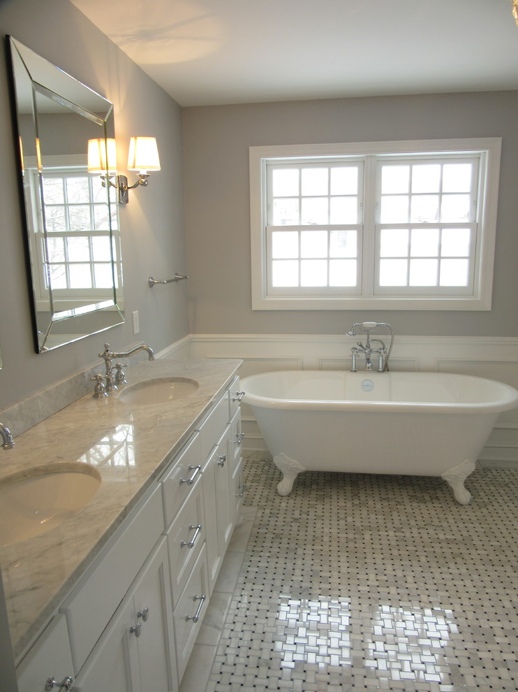Large traditional ensuite bathroom in Minneapolis with shaker cabinets, white cabinets, a claw-foot bath, a corner shower, a two-piece toilet, grey tiles, stone tiles, grey walls, marble flooring, a submerged sink and marble worktops.