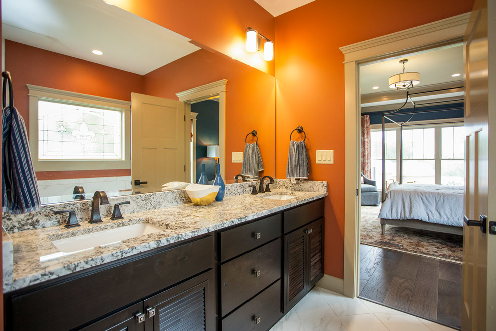 Foto på ett mellanstort vintage en-suite badrum, med skåp i mörkt trä, granitbänkskiva, ett platsbyggt badkar, en dusch i en alkov, stenkakel, luckor med lamellpanel, orange väggar, marmorgolv och ett undermonterad handfat
