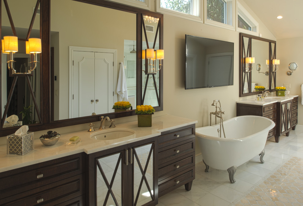 Large cottage master porcelain tile bathroom photo in New York with recessed-panel cabinets, dark wood cabinets, a one-piece toilet, beige walls, an undermount sink and marble countertops