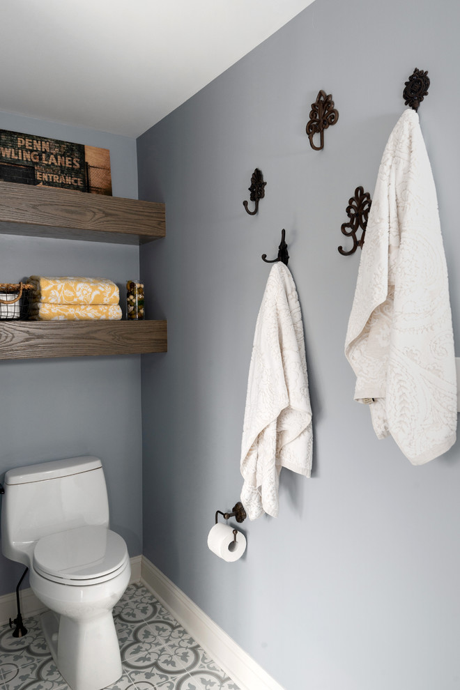 Example of a large transitional master porcelain tile and multicolored floor bathroom design in Other with shaker cabinets, medium tone wood cabinets, blue walls, a vessel sink, marble countertops, a hinged shower door and blue countertops