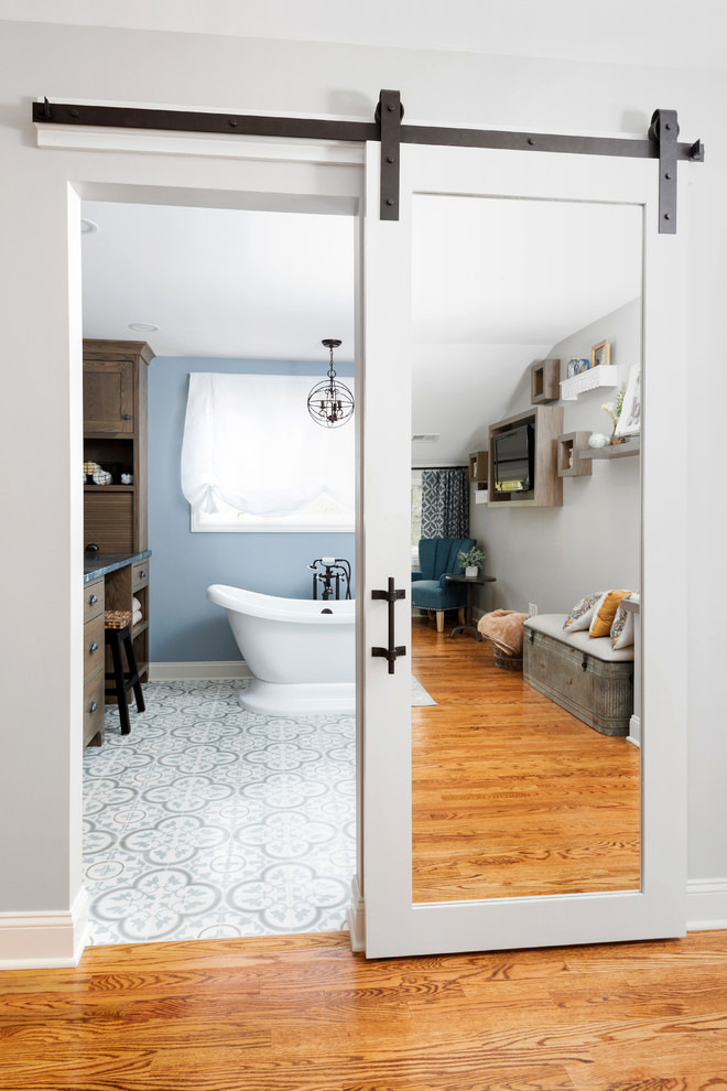 Inspiration for a large transitional master porcelain tile and multicolored floor bathroom remodel in Other with shaker cabinets, medium tone wood cabinets, blue walls, a vessel sink, marble countertops, a hinged shower door and blue countertops