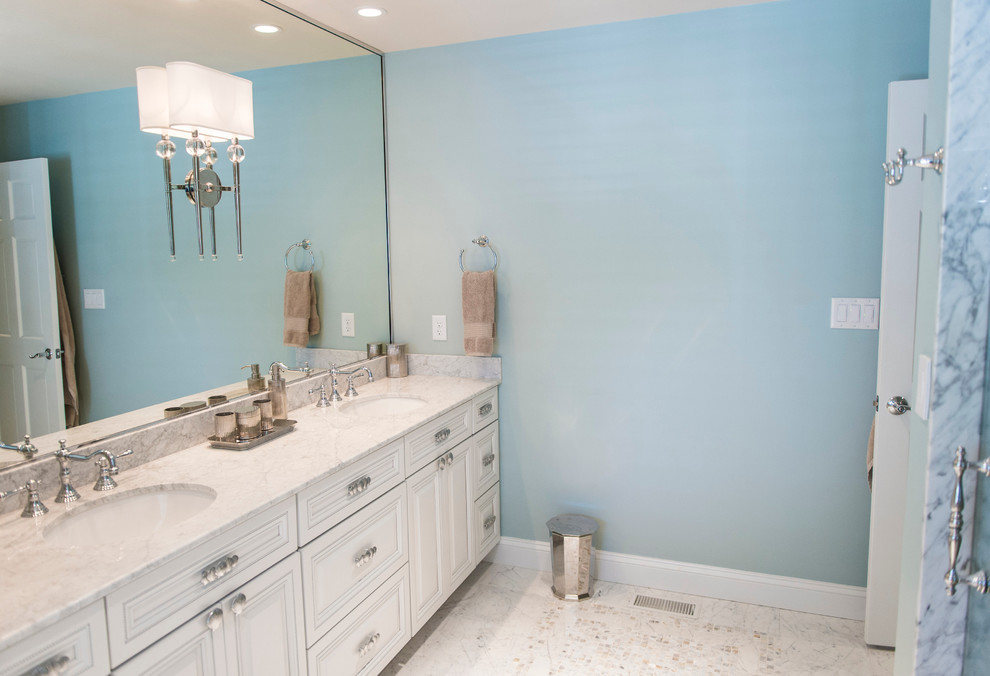This is an example of a medium sized coastal ensuite bathroom in Philadelphia with a submerged sink, raised-panel cabinets, white cabinets, onyx worktops, white tiles, stone tiles, blue walls and marble flooring.