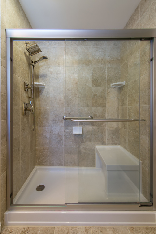 This is an example of a large classic ensuite bathroom in Boston with a submerged sink, recessed-panel cabinets, dark wood cabinets, granite worktops, a freestanding bath, an alcove shower, a two-piece toilet, beige tiles, ceramic tiles, green walls and travertine flooring.