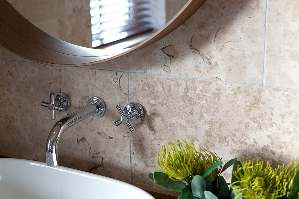 Photo of a coastal bathroom in Other with limestone tiles and porcelain flooring.