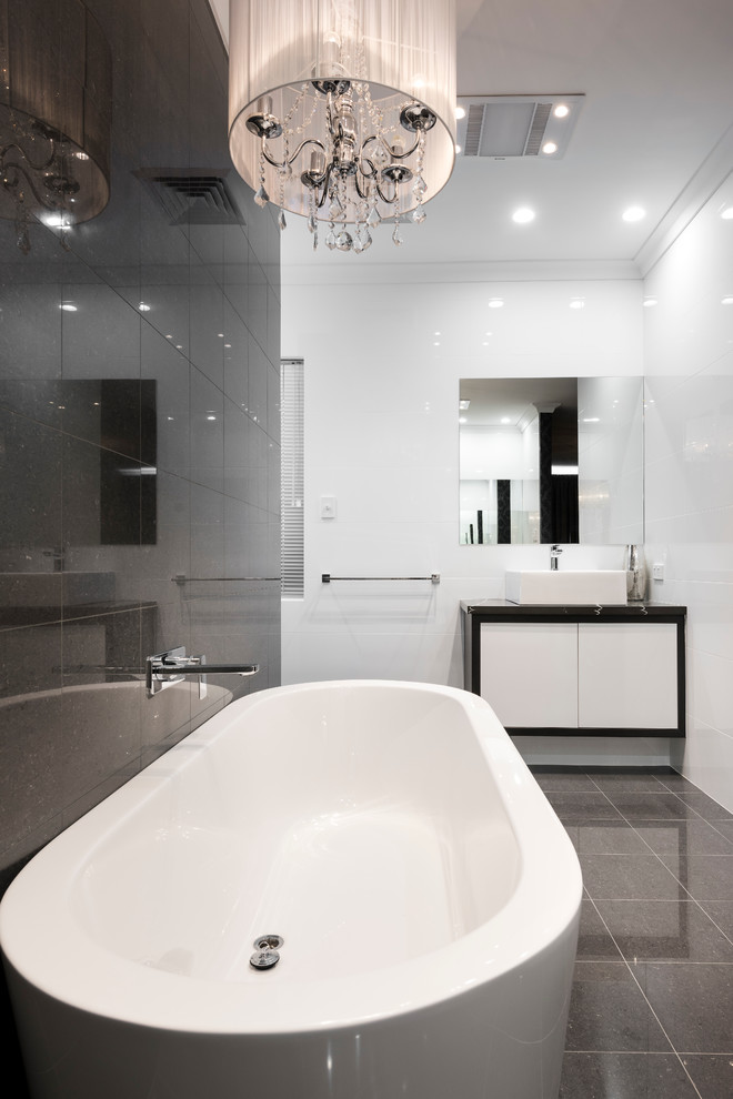 Inspiration for a large contemporary master white tile and porcelain tile porcelain tile bathroom remodel in Perth with recessed-panel cabinets, white cabinets, a one-piece toilet, white walls, a vessel sink and quartz countertops