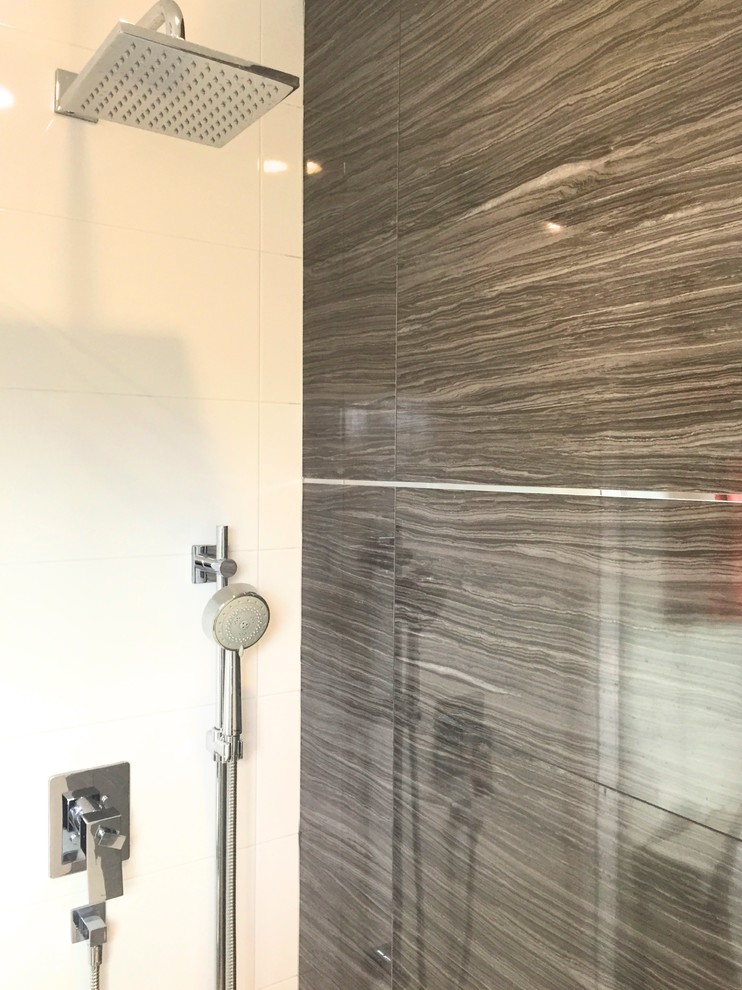 Inspiration for a medium sized classic shower room bathroom in Toronto with flat-panel cabinets, white cabinets, an alcove shower, grey tiles, porcelain tiles, white walls, porcelain flooring, an integrated sink, solid surface worktops, grey floors and a sliding door.