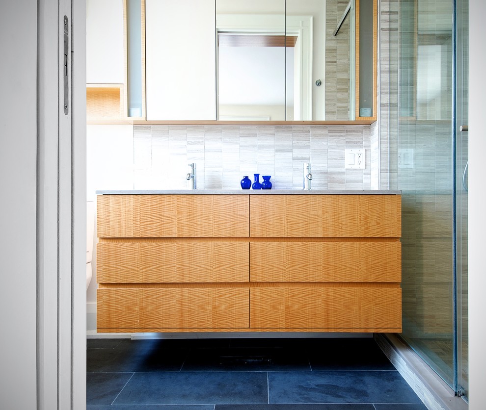 Medium sized modern ensuite bathroom in Toronto with flat-panel cabinets, medium wood cabinets, an alcove shower, multi-coloured tiles, matchstick tiles, beige walls, a submerged sink, blue floors and a sliding door.