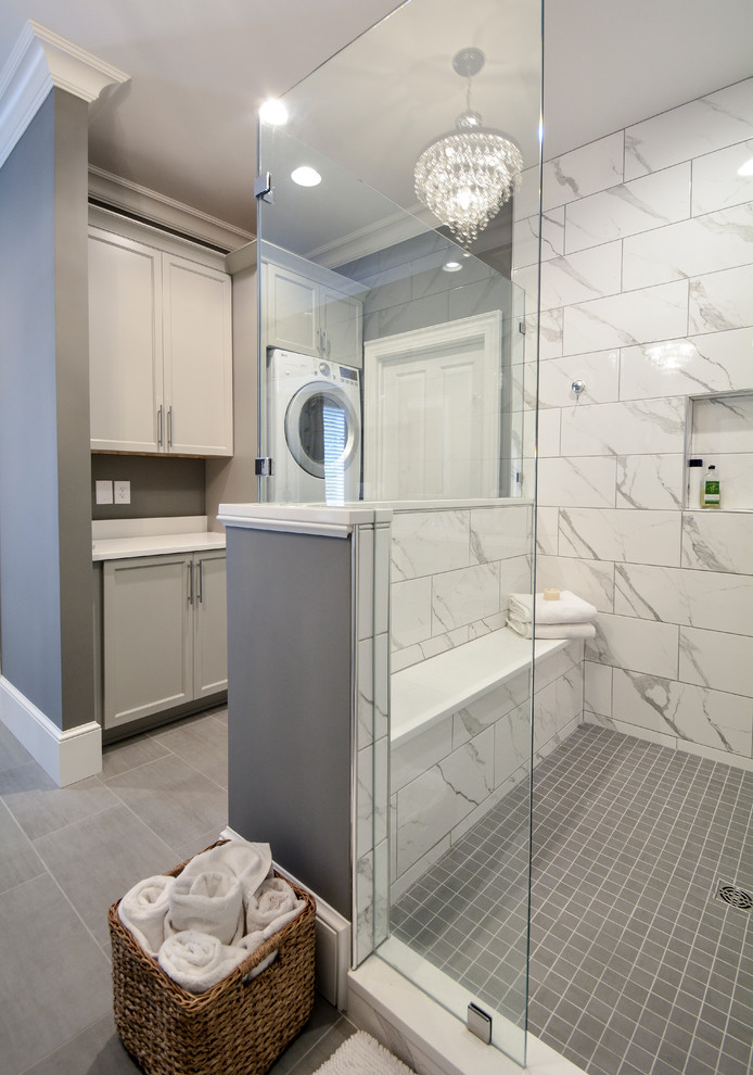 На фото: главная ванная комната среднего размера в стиле неоклассика (современная классика) с фасадами в стиле шейкер, серыми фасадами, двойным душем, раздельным унитазом, серой плиткой, керамогранитной плиткой, серыми стенами, полом из керамогранита, врезной раковиной, столешницей из искусственного кварца, серым полом, душем с распашными дверями и белой столешницей с