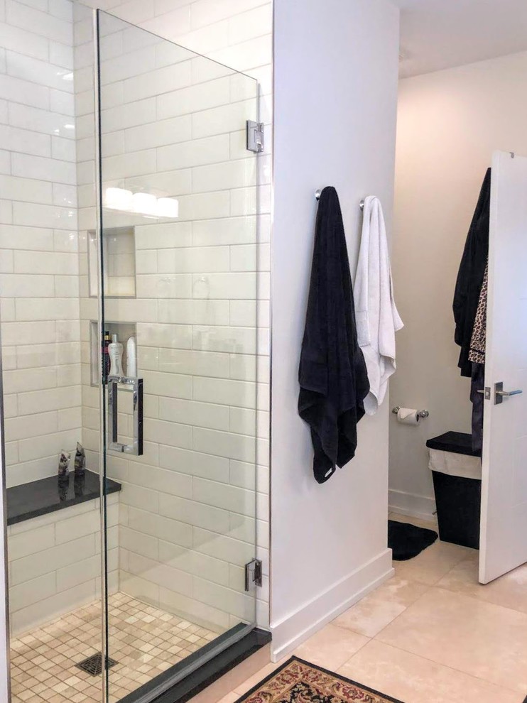 Bild på ett mellanstort funkis svart svart en-suite badrum, med svarta skåp, ett fristående badkar, vita väggar, bänkskiva i kvartsit, beiget golv, dusch med gångjärnsdörr, släta luckor och klinkergolv i porslin