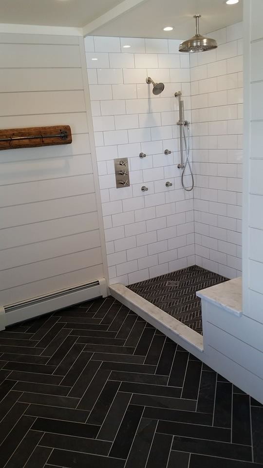Inspiration for a mid-sized farmhouse master black and white tile and stone tile slate floor freestanding bathtub remodel in Burlington with furniture-like cabinets, medium tone wood cabinets, a two-piece toilet, beige walls, an integrated sink and marble countertops