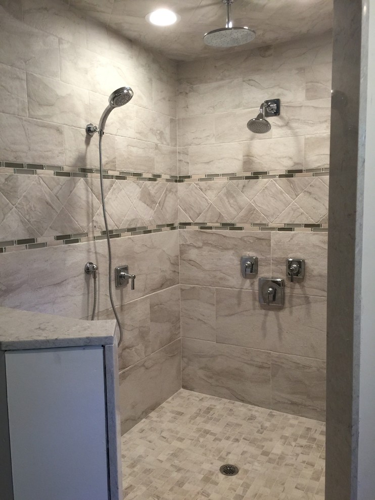 Photo of a medium sized contemporary ensuite bathroom in New York with a corner shower and grey tiles.