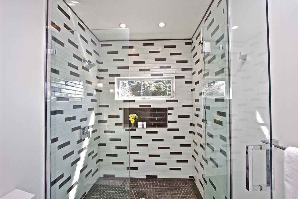 Example of a mid-sized 1960s master black tile and ceramic tile porcelain tile alcove shower design in San Francisco with an integrated sink, flat-panel cabinets, white cabinets, a one-piece toilet and white walls