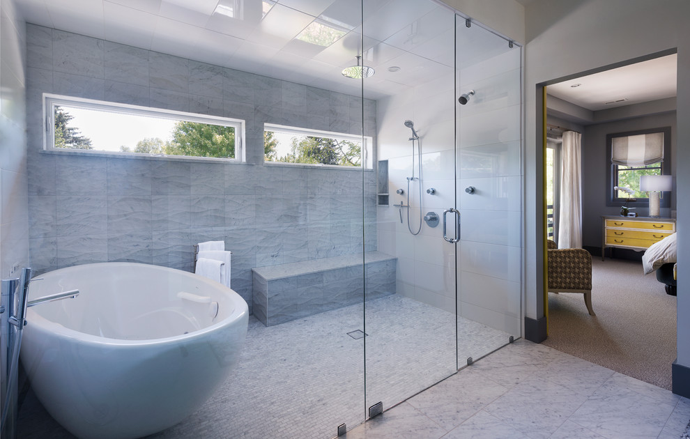 Inspiration for a contemporary ensuite bathroom in Denver with a freestanding bath, a built-in shower, grey tiles and feature lighting.