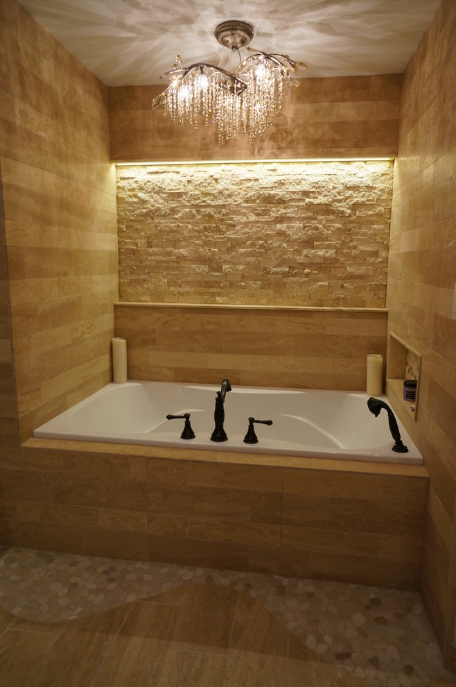 This is an example of a medium sized mediterranean ensuite bathroom in Philadelphia with an alcove bath, an alcove shower, stone tiles and porcelain flooring.
