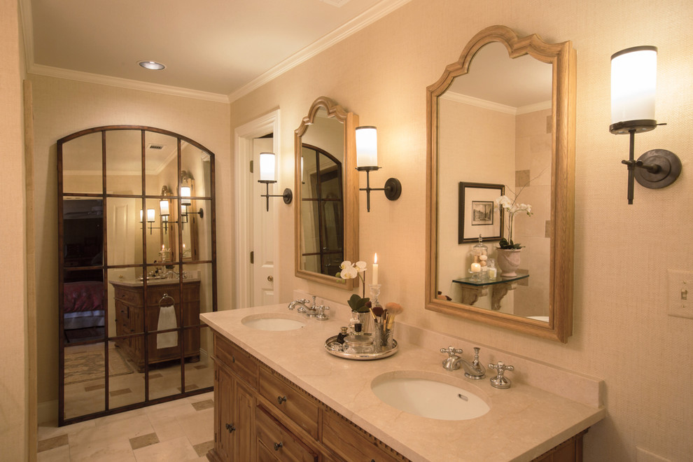 Inspiration for a medium sized mediterranean ensuite bathroom in Dallas with freestanding cabinets, distressed cabinets, a freestanding bath, an alcove shower, a two-piece toilet, beige tiles, travertine tiles, beige walls, travertine flooring, a submerged sink, marble worktops, beige floors and a hinged door.