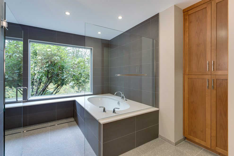 Large contemporary ensuite bathroom in Other with shaker cabinets, medium wood cabinets, a corner bath, a corner shower, brown tiles, porcelain tiles, white walls, a submerged sink, engineered stone worktops, grey floors, a hinged door and white worktops.