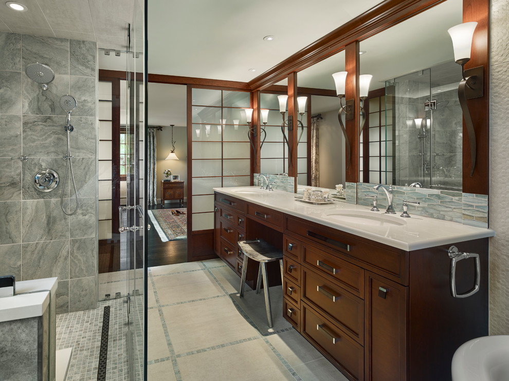 Bathroom - large traditional master gray tile and ceramic tile ceramic tile bathroom idea in Philadelphia with raised-panel cabinets, a wall-mount toilet, gray walls, an undermount sink, quartz countertops and dark wood cabinets