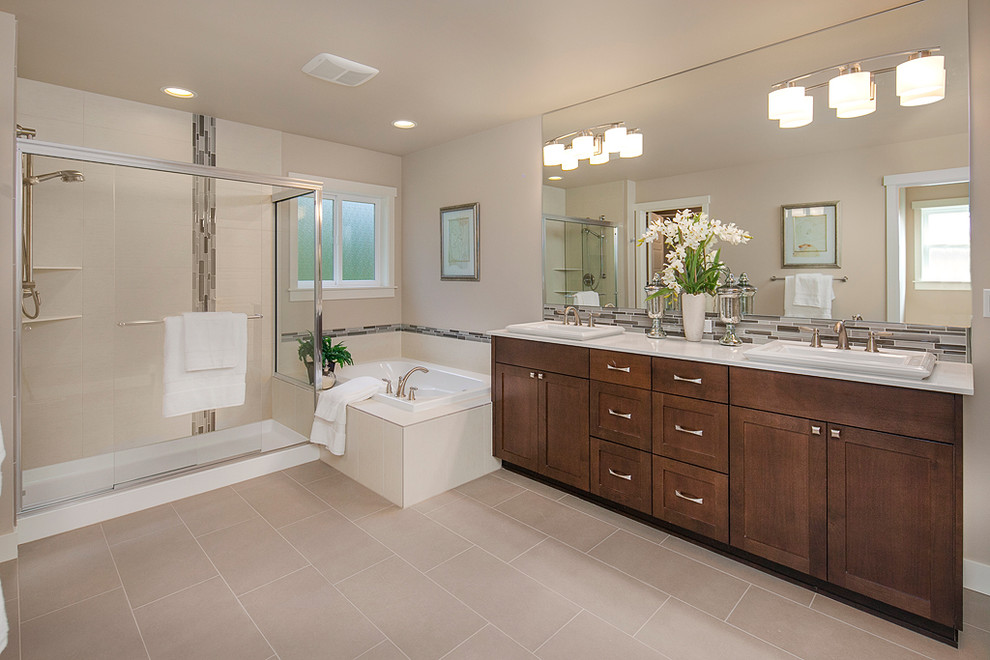 Inspiration for a craftsman master multicolored tile and glass tile porcelain tile bathroom remodel in Seattle with a drop-in sink, recessed-panel cabinets, medium tone wood cabinets, quartz countertops and beige walls