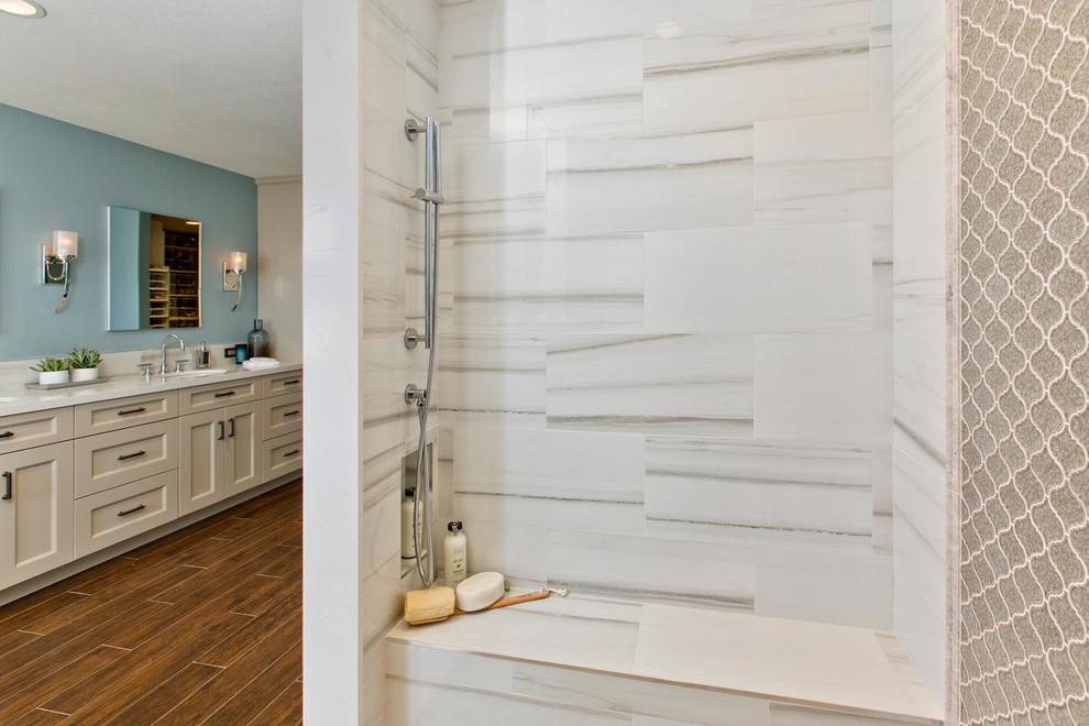 Example of a large classic master yellow tile and porcelain tile porcelain tile bathroom design in Denver with recessed-panel cabinets, white cabinets, a wall-mount toilet, blue walls, an undermount sink and quartz countertops