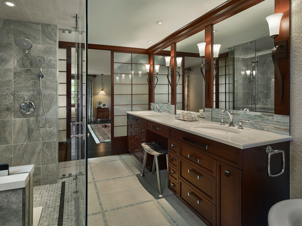 Inspiration for a large classic ensuite bathroom in Philadelphia with recessed-panel cabinets, dark wood cabinets, a built-in shower, grey tiles, a submerged sink, a freestanding bath, a wall mounted toilet, ceramic tiles, beige walls and engineered stone worktops.