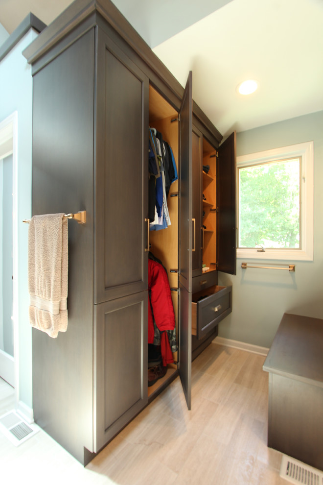 Example of a large transitional limestone floor and gray floor closet design in Other with recessed-panel cabinets and gray cabinets