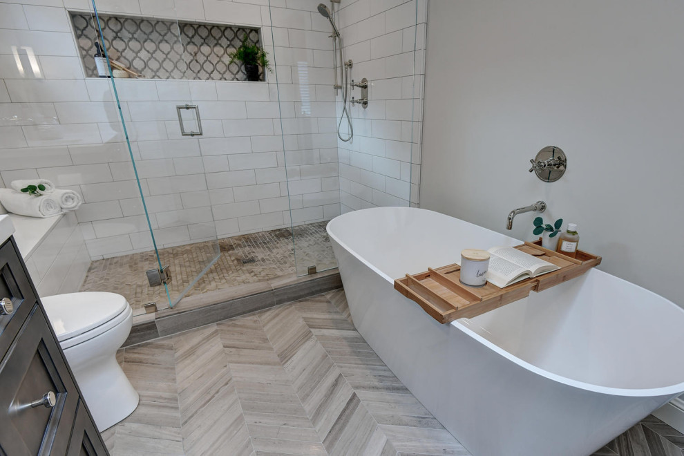 This is an example of a large contemporary ensuite bathroom in San Francisco with raised-panel cabinets, brown cabinets, a one-piece toilet, white tiles, mosaic tiles, white walls, cement flooring, a submerged sink, quartz worktops, grey floors, a hinged door, white worktops, a freestanding bath, a built-in shower, double sinks and a built in vanity unit.
