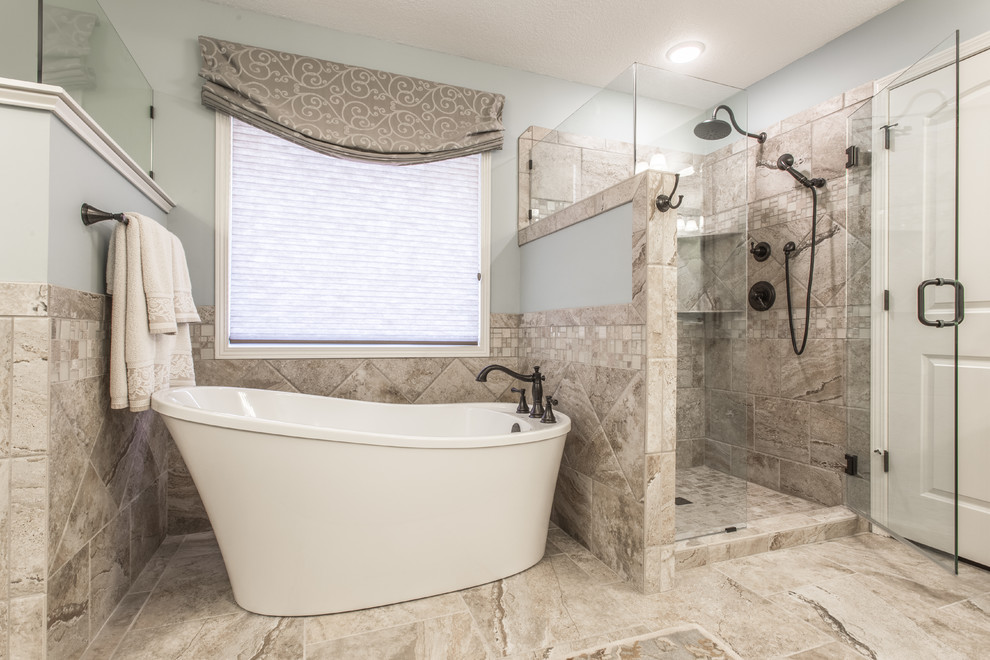 Design ideas for a large traditional ensuite bathroom in Kansas City with a freestanding bath, an alcove shower, brown tiles, porcelain tiles, grey walls, porcelain flooring, brown floors, a sliding door, raised-panel cabinets, light wood cabinets, a submerged sink and granite worktops.